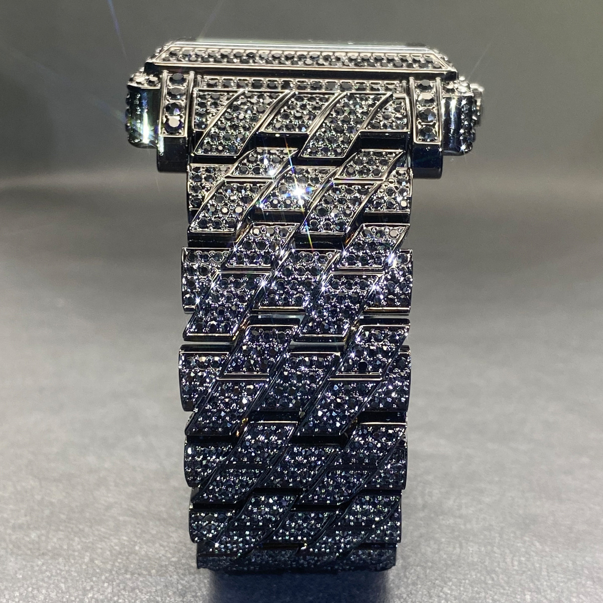 Moissanite watch with a square case stylized numerals.