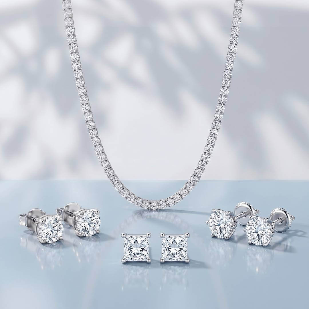 Classic Prong Jewelry Collection featuring moissanite diamond necklace, studs, and ring