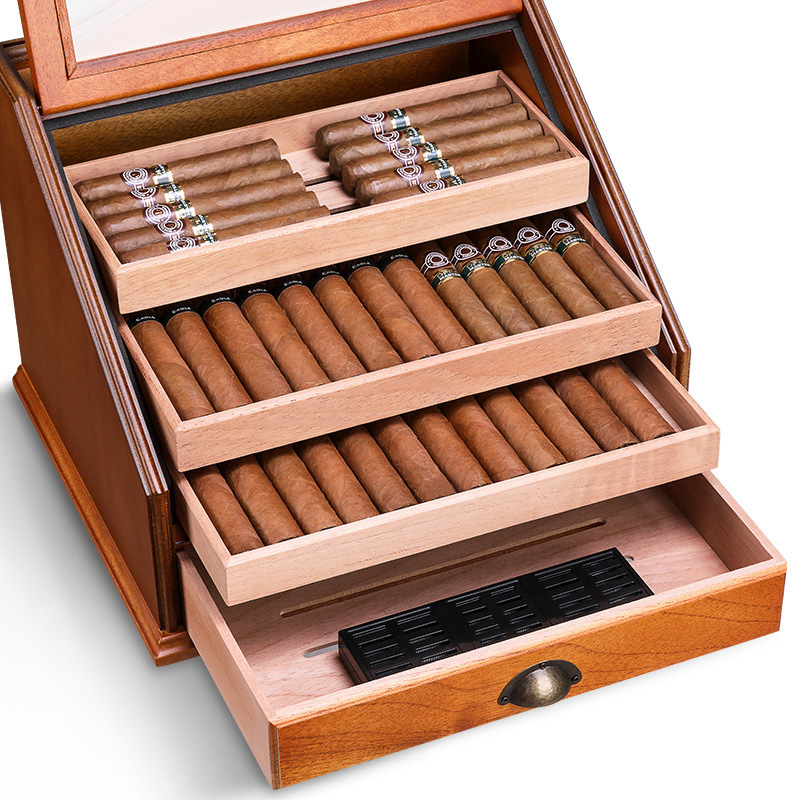Tiered wooden cigar trays inside a cedar display humidor