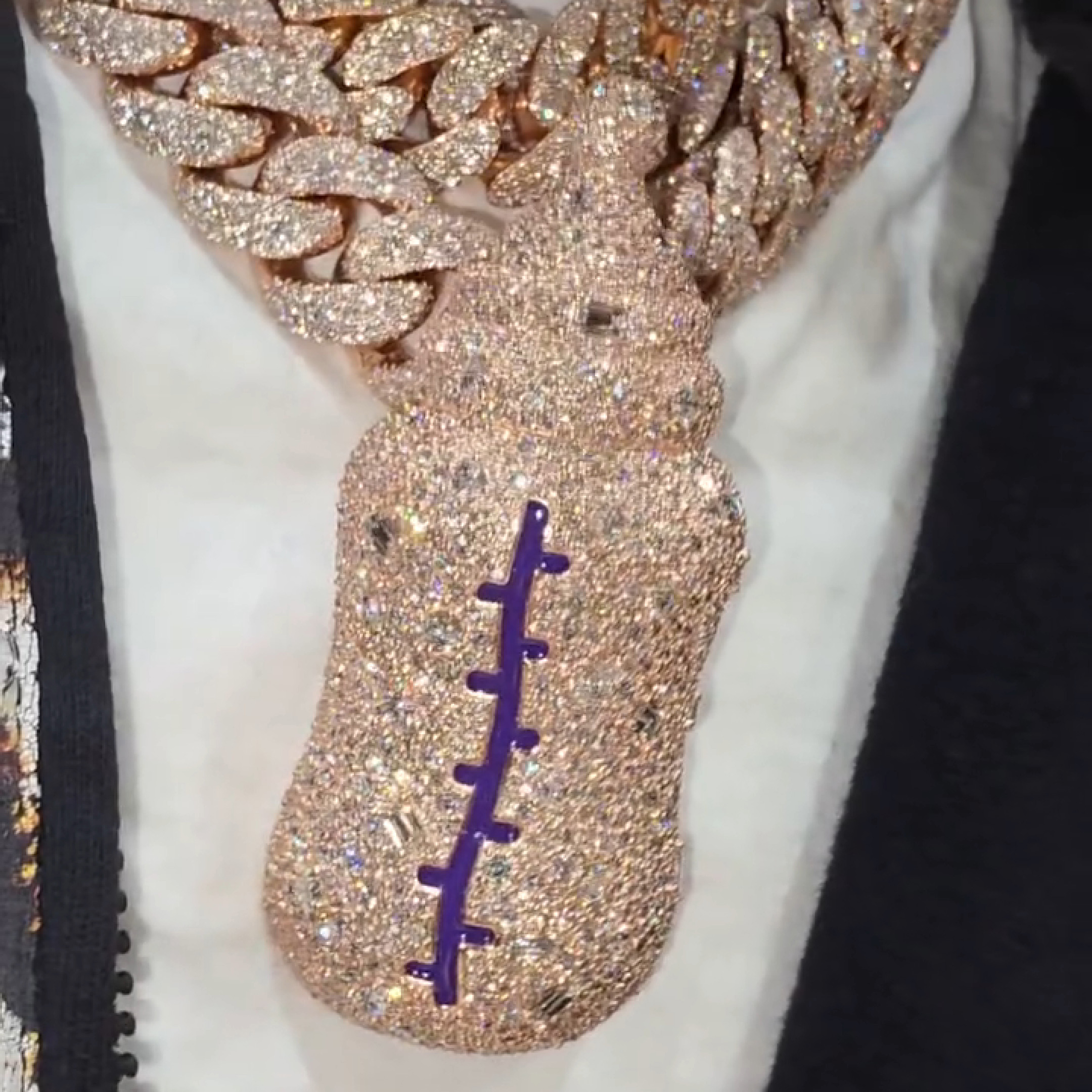 Close-up of emerald rounds, ovals, and pear-shaped stones in New Bottle pendant
