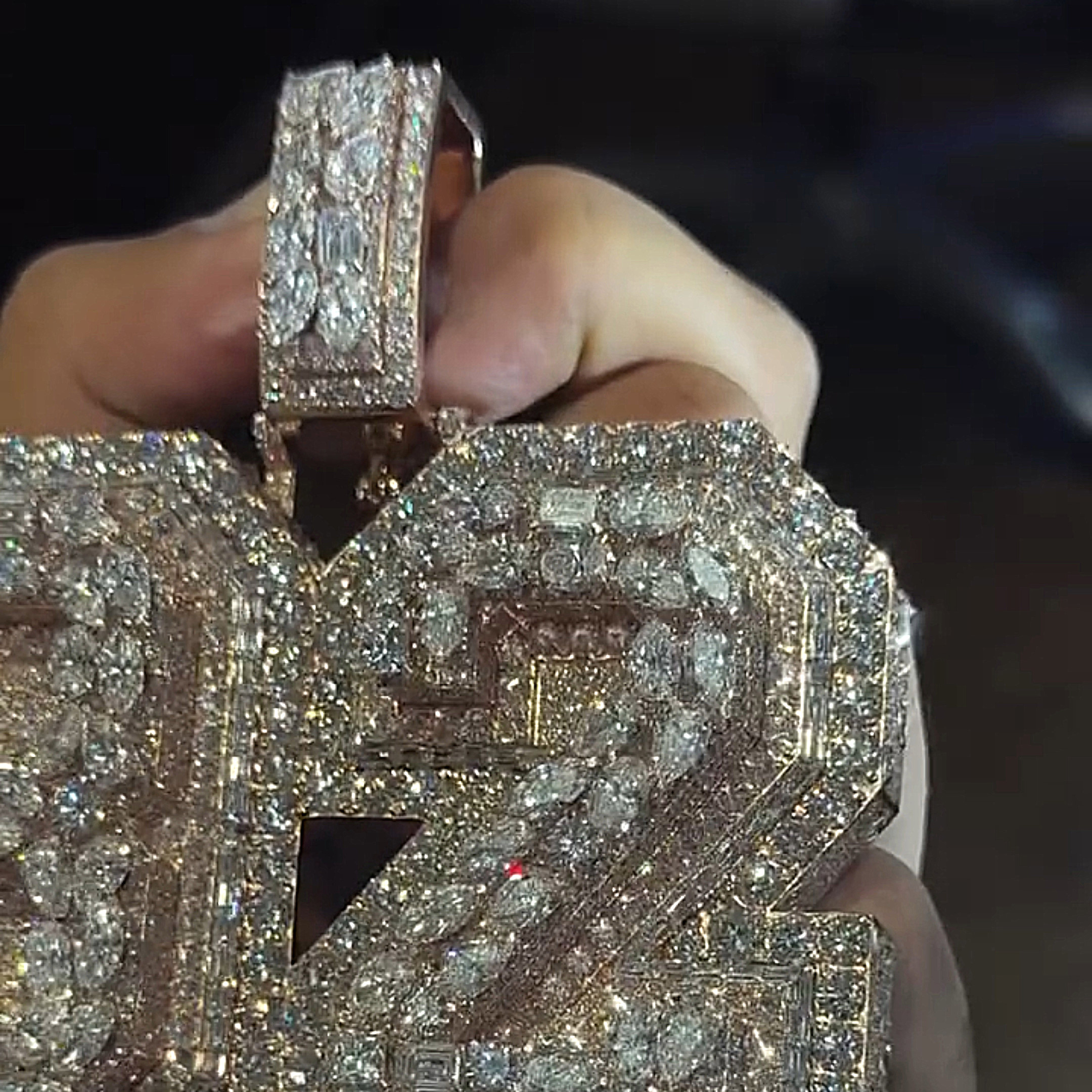 rose gold 32 pendant with GANG MILLIONAIRES letters angled view premium stone detailing
