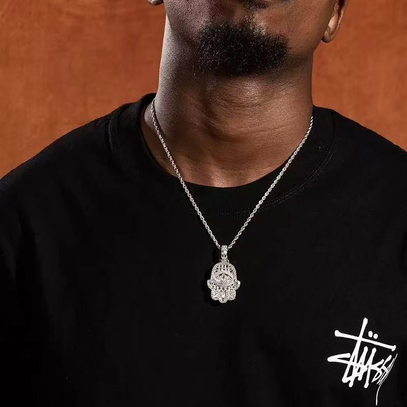 model wearing white gold hamsa hand pendant luxury streetwear jewelry look