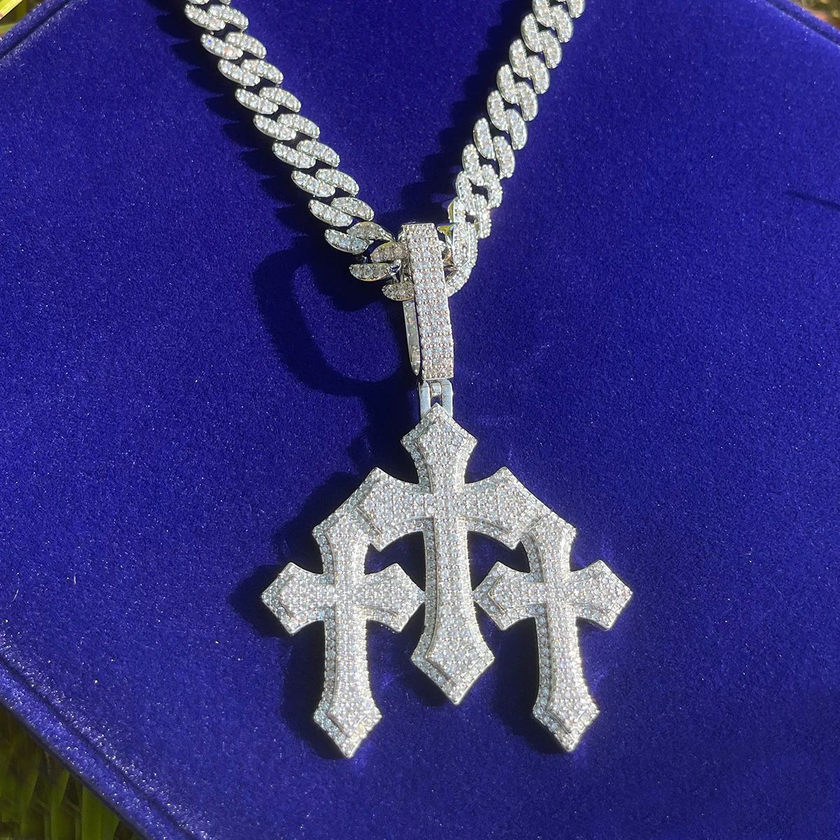 triple ornamental cross pendant close up stone detailing luxury jewelry