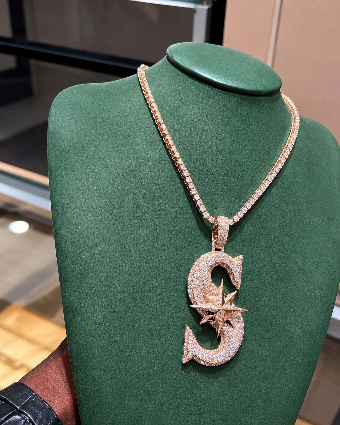 Iced out rose gold S pendant with star compass centerpiece and CZ stones