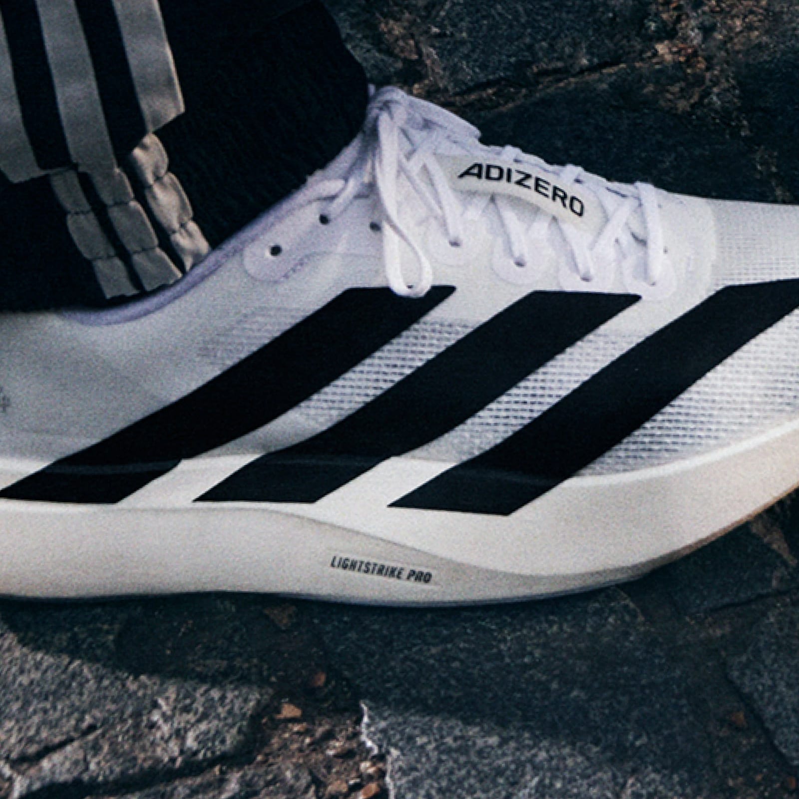 A closeup image shows the black and white Evo SL shoe  highlighting the Lightstrike Pro lettering on the sole.