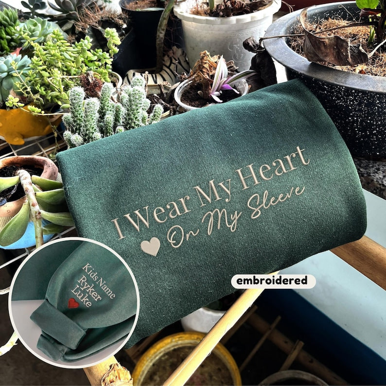 Embroidered I Wear My Heart On My Sleeve Sweatshirt, Custom Mama Sweatshirt with Kids Name on Sleeve, Christmas Mother Day Gift for Mom-ilovevango