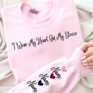 I Wear My Heart On My Sleeve Sweatshirt and Hoodie, Custom Family Gift Hoodie, Gift for Mom, Custom Mama Sweatshirt with Name on Sleeve-ilovevango