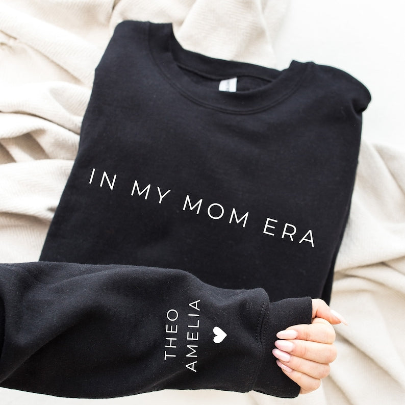 In My Mom Era With Kid Name On Sleeve Sweatshirt, Mama Sweatshirt, Mama shirt, Gift For Mom, Mother Day Gift, Mom Life Shirt, Mama Crewneck-ilovevango