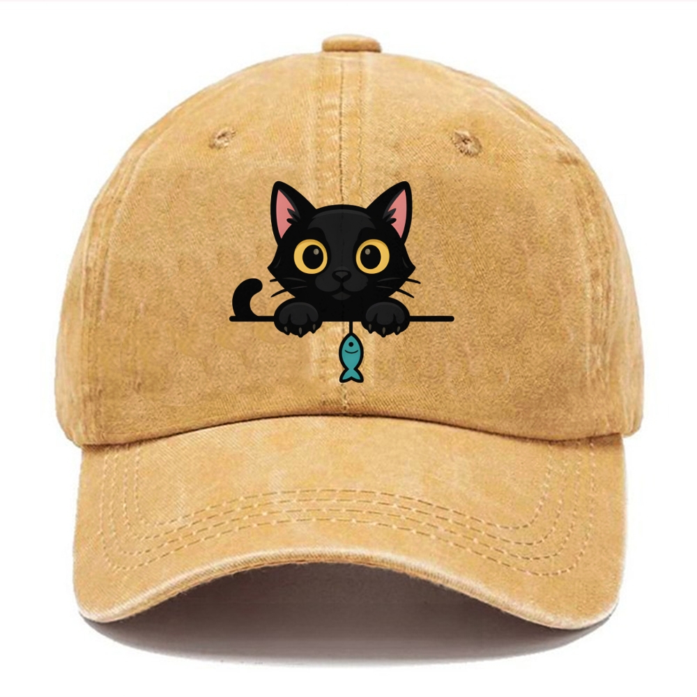 Midnight the black cat holding a tiny yarn ball between both paws while peeking Washed Cap