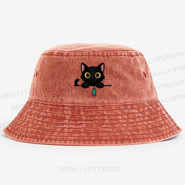 Midnight the black cat holding a tiny yarn ball between both paws while peeking Washed Bucket Hat