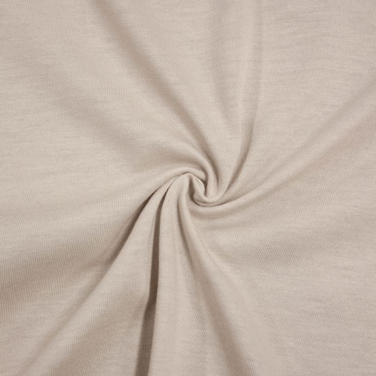 This may contain: the fabric is very soft and light beige with a small amount of wrinkles on it