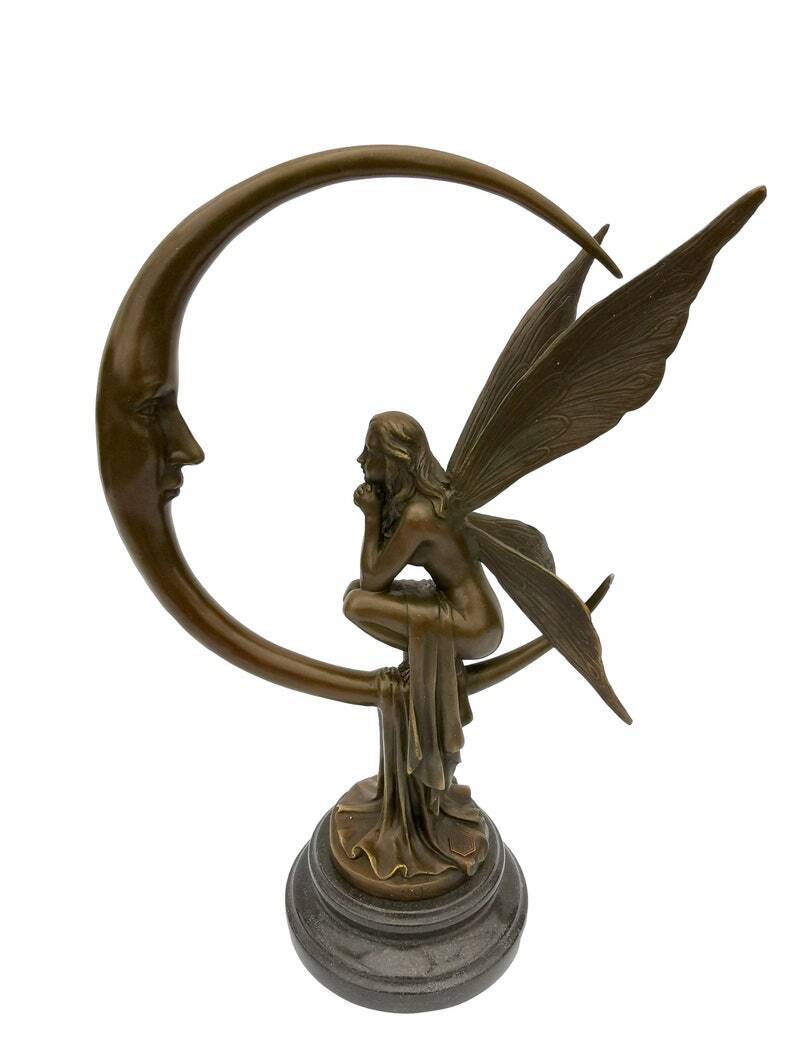 Amazing bronze sculpture of a bronze fairy sitting on the moon