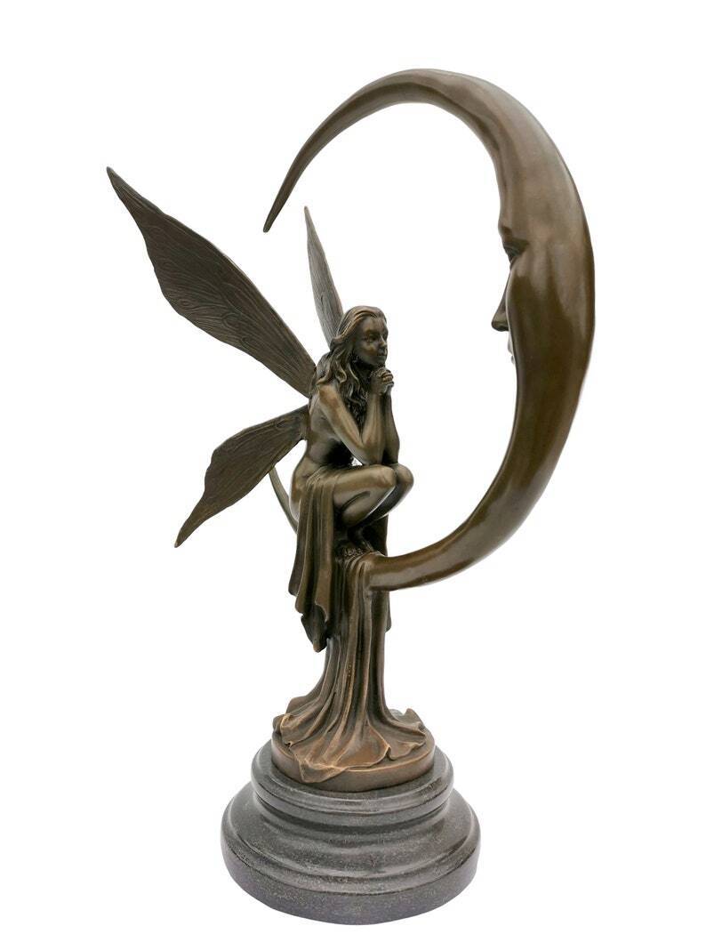 Amazing bronze sculpture of a bronze fairy sitting on the moon