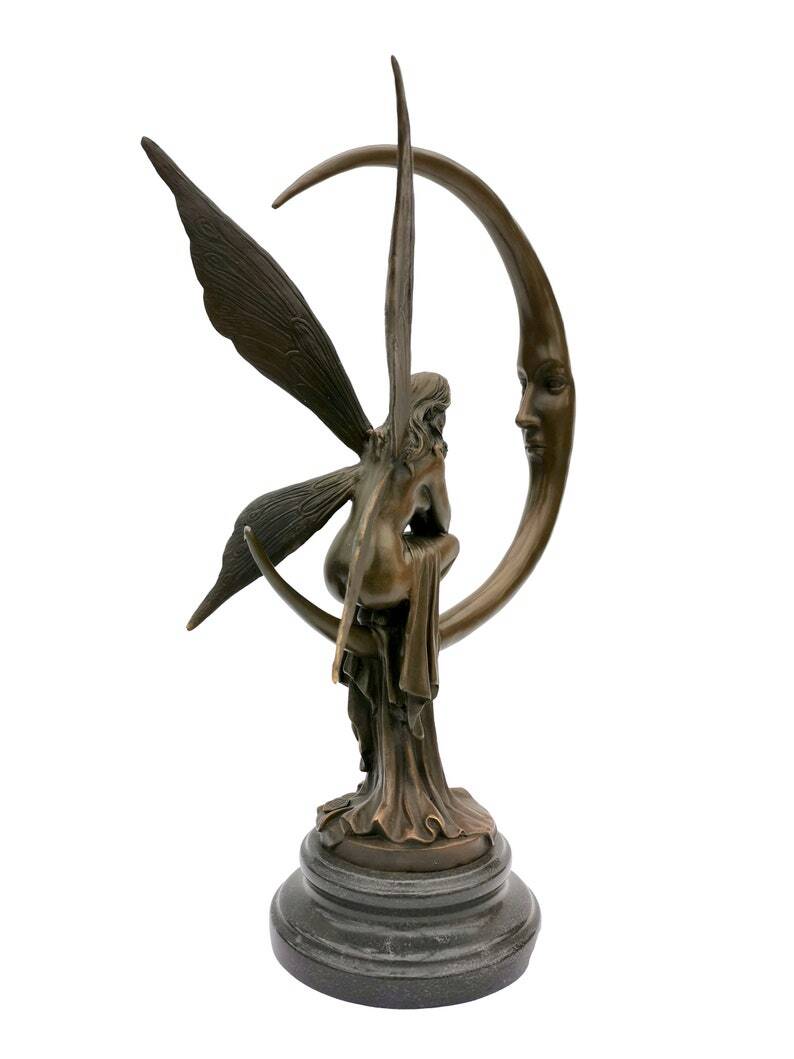 Amazing bronze sculpture of a bronze fairy sitting on the moon