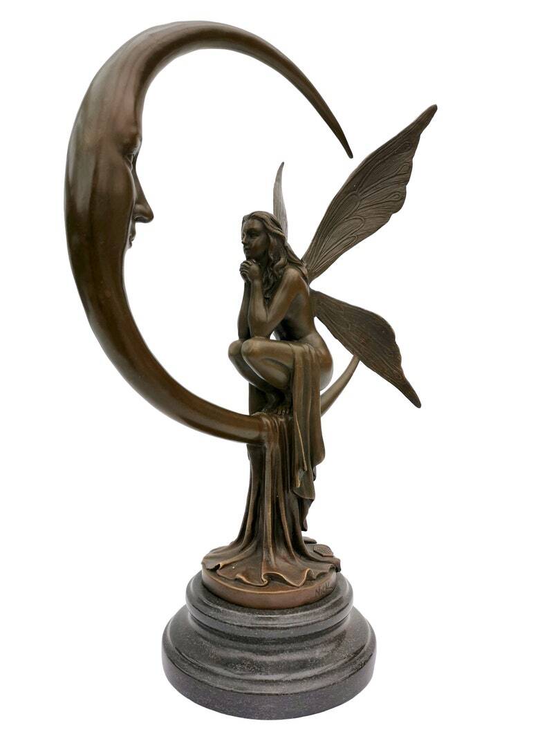 Amazing bronze sculpture of a bronze fairy sitting on the moon