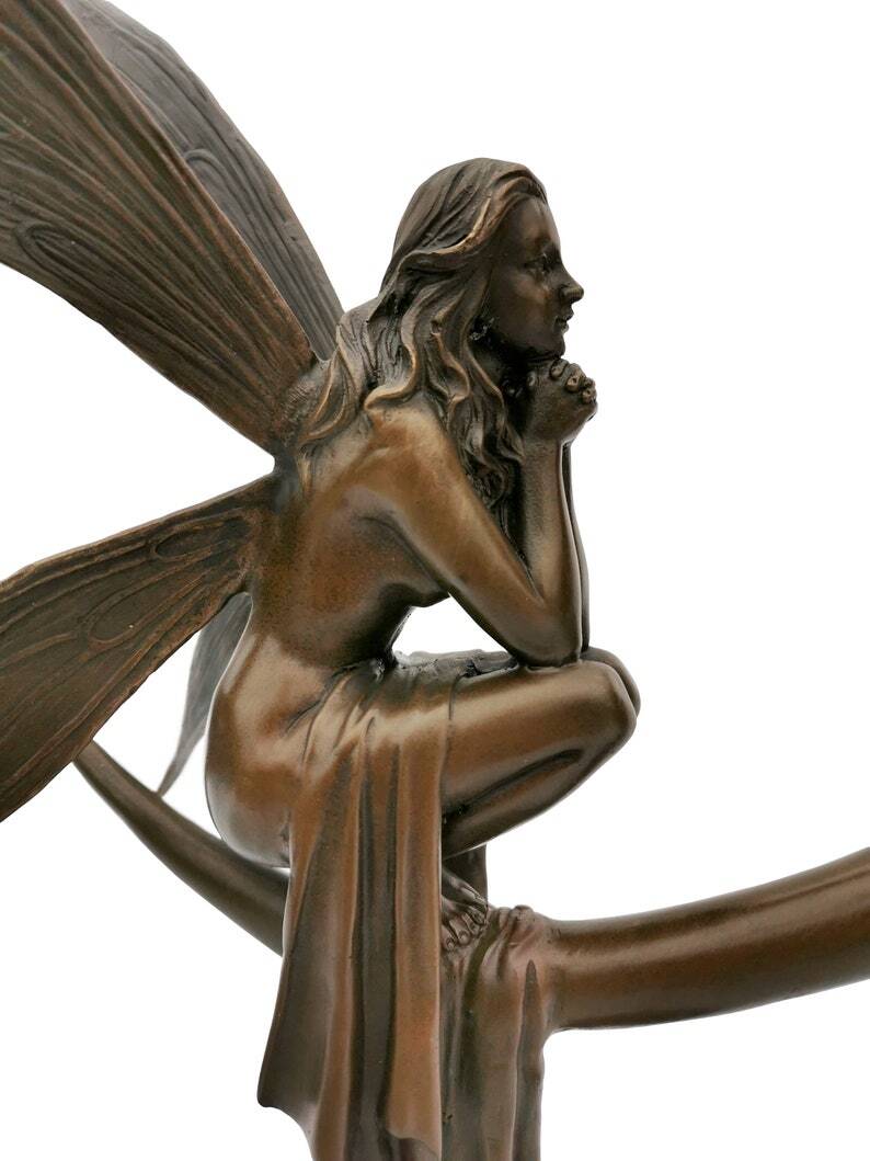 Amazing bronze sculpture of a bronze fairy sitting on the moon