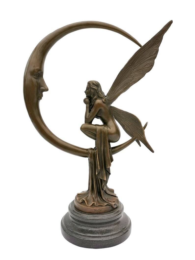 Amazing bronze sculpture of a bronze fairy sitting on the moon