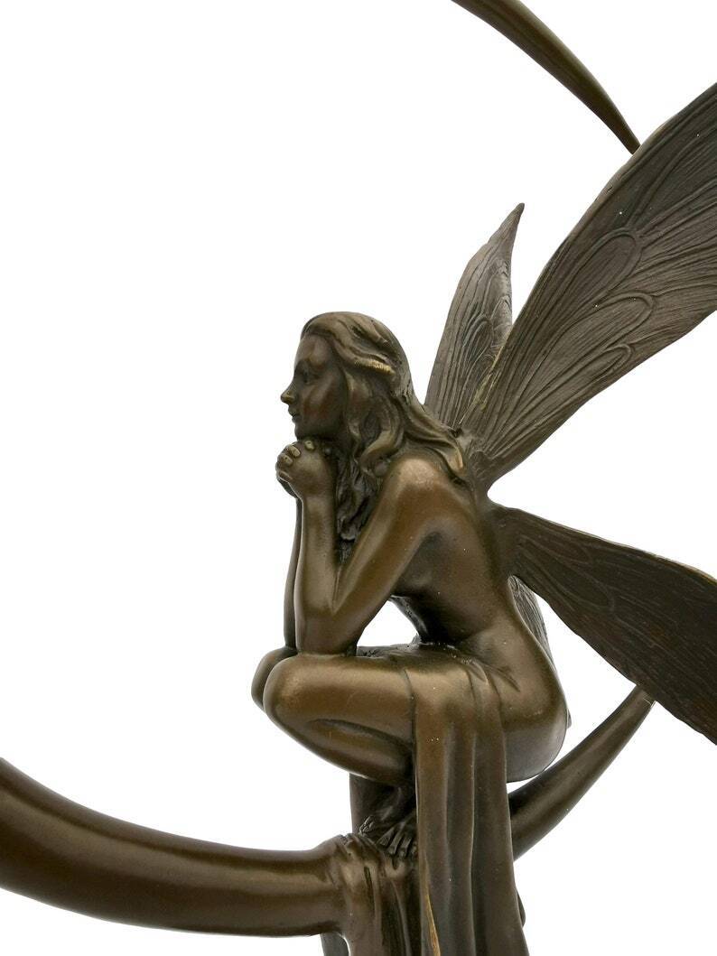 Amazing bronze sculpture of a bronze fairy sitting on the moon