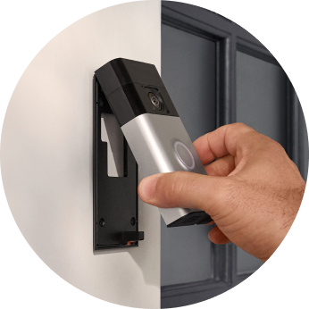 2) Ring Battery Video Doorbell is being slotted into its mount. 