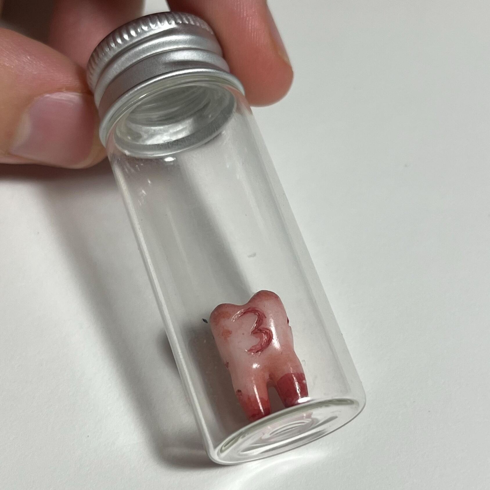Replica life-sized Molar 4-sided dice prop for ttrpg and DnD