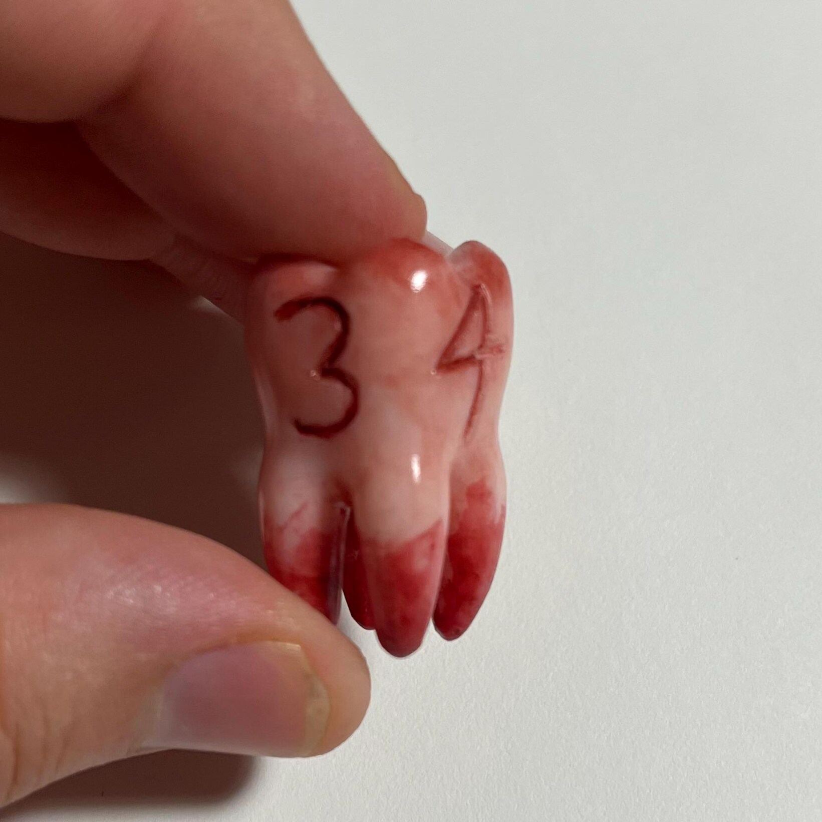 Replica life-sized Molar 4-sided dice prop for ttrpg and DnD