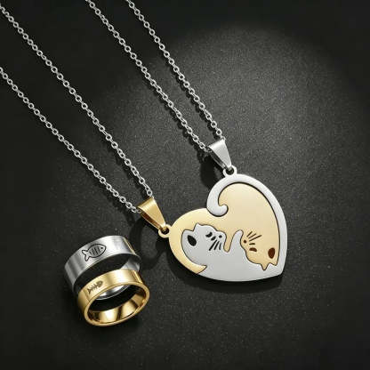 Two-piece friendship necklaces and rings set featuring a silver fish ring and a heart-shaped pendant with a cat and fish design, shown on a dark textured background.
