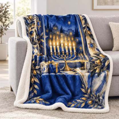 The blue and white plush menorah blanket is draped over a grey sofa in a bright living room