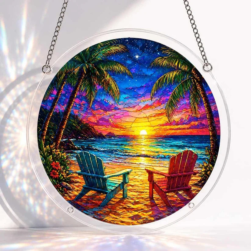 A round acrylic suncatcher showing a tropical beach sunset with two adirondack chairs palm trees and starry sky
