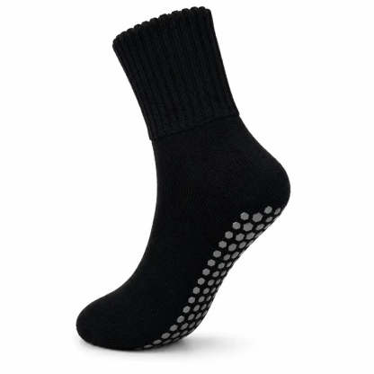 A single black ankle sock with gray non-slip grip dots on the sole, shown against a plain white background.