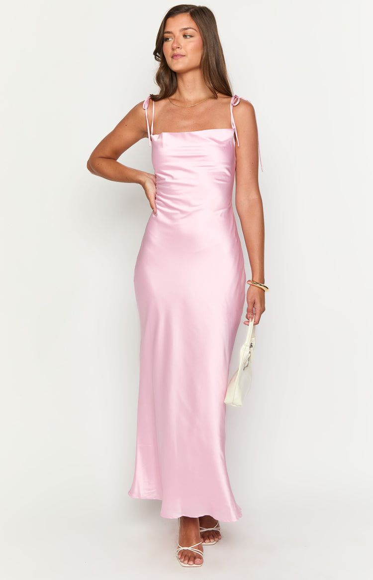 back shot of a blonde girl wearing a pink satin gown with tie back details styled with nude heels and silver bracelets