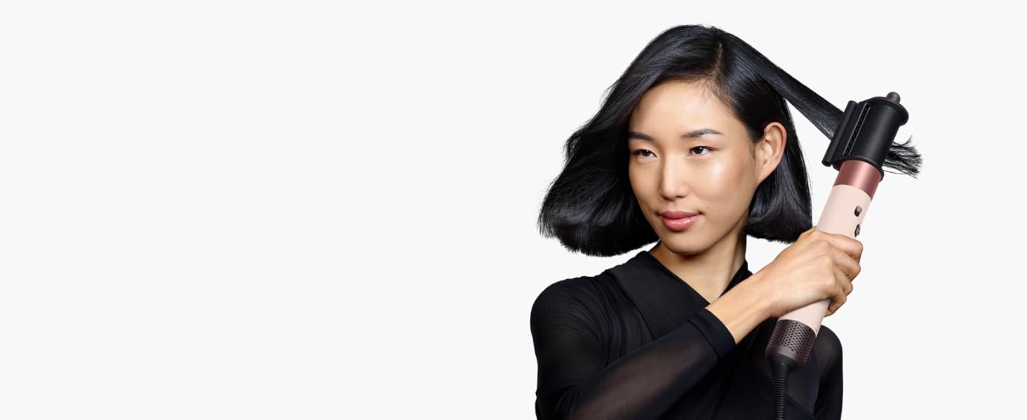 Model uses the Dyson Airwrap i.d. with the Dryer+Flyaway smoother attachment to style her hair.