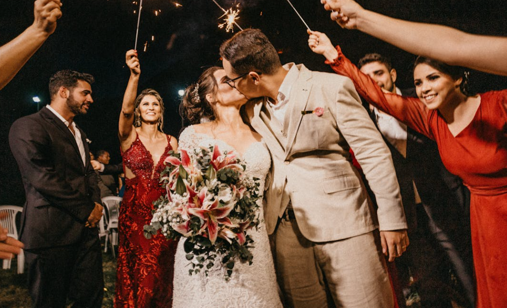 Yesbayonline Bride in a lace wedding dress and groom in a suit at a romantic nighttime wedding