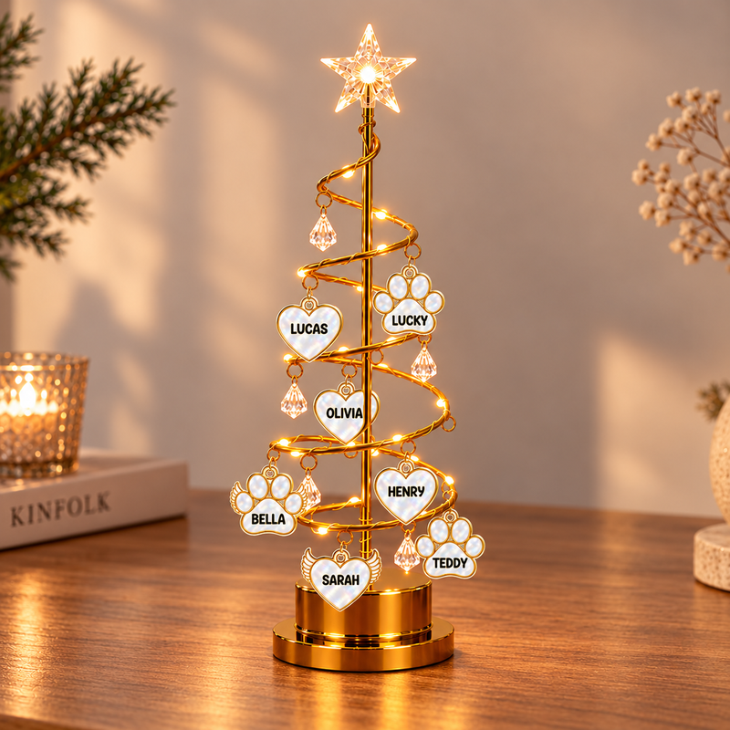 Full view of the personalised tree light with seven example name charms and glowing star topper.