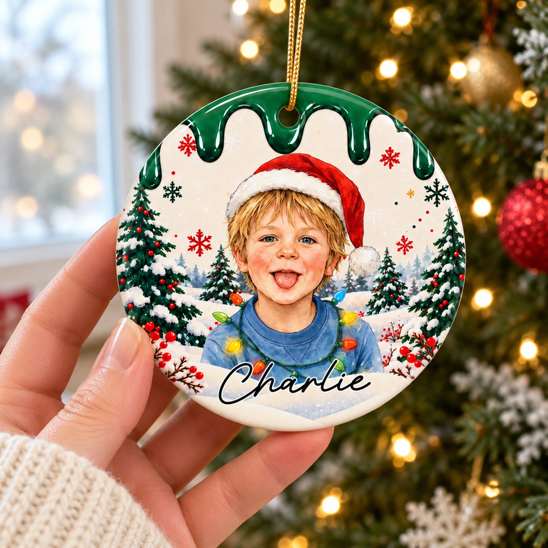 Hand-held green Charlie Christmas portrait ornament with printed winter illustration.
