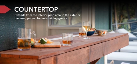 Photo of the Solara's bar countertop with food and drinks staged on top. Text reads, "Countertop. Extends from the interior prep area to the exterior bar area; perfect for entertaining guests."