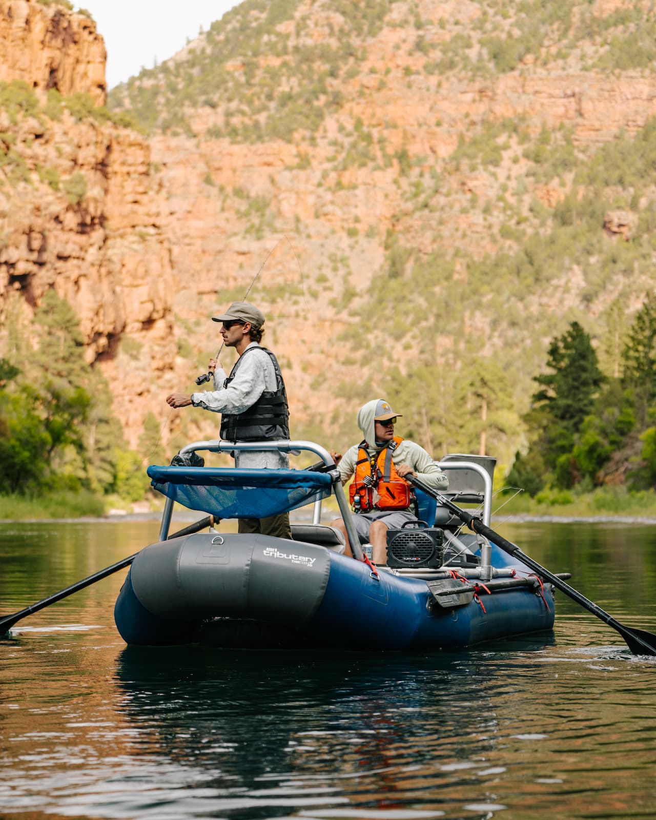 Two guys fishing on boat with their Turtlebox.