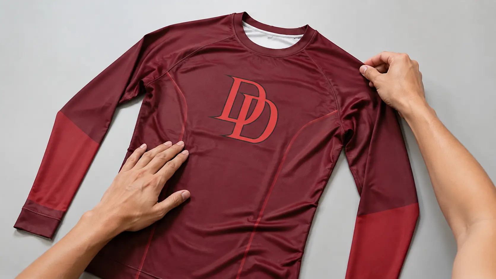 Illustration of a burgundy compression shirt on a clean worktable