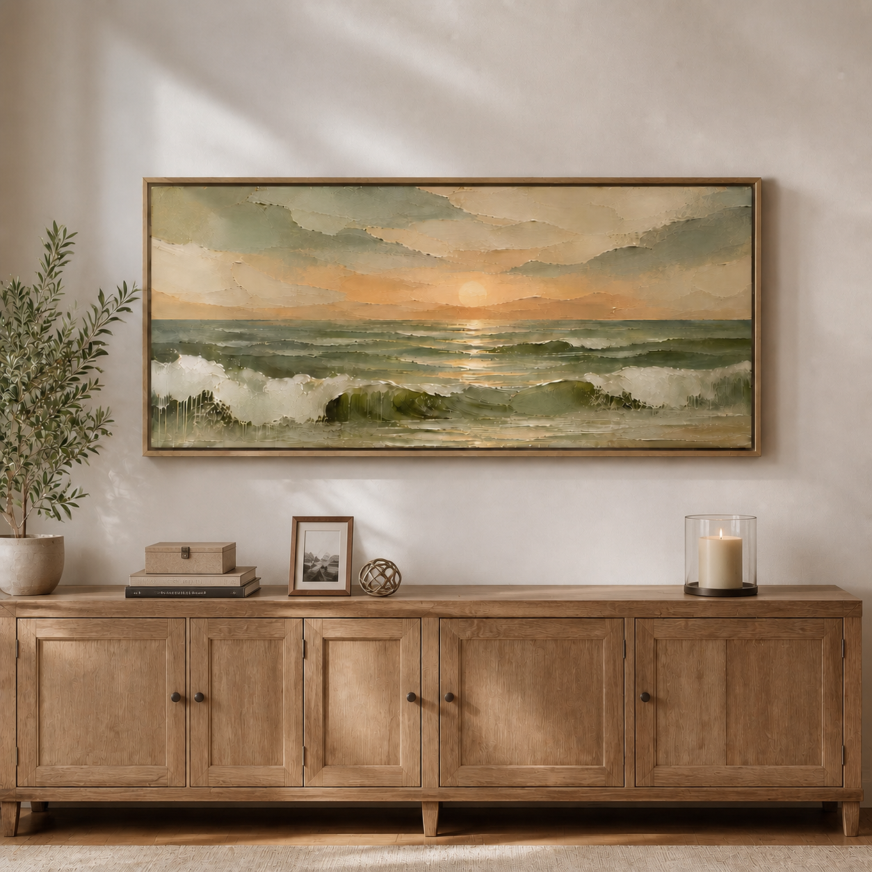 Golden sun above sage-green ocean waves with white foam and warm cream clouds, shown in a room setting