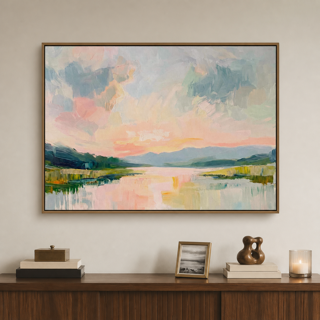 Large horizontal pastel landscape wall art with a pink-and-blue sky, distant hills and calm reflective water above a wood entryway cabinet