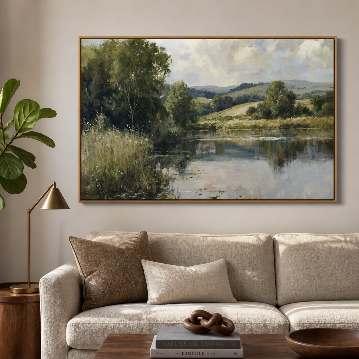 Leafy green trees and grasses beside a reflective lake with rolling hills and a cloudy blue sky, shown in a room setting