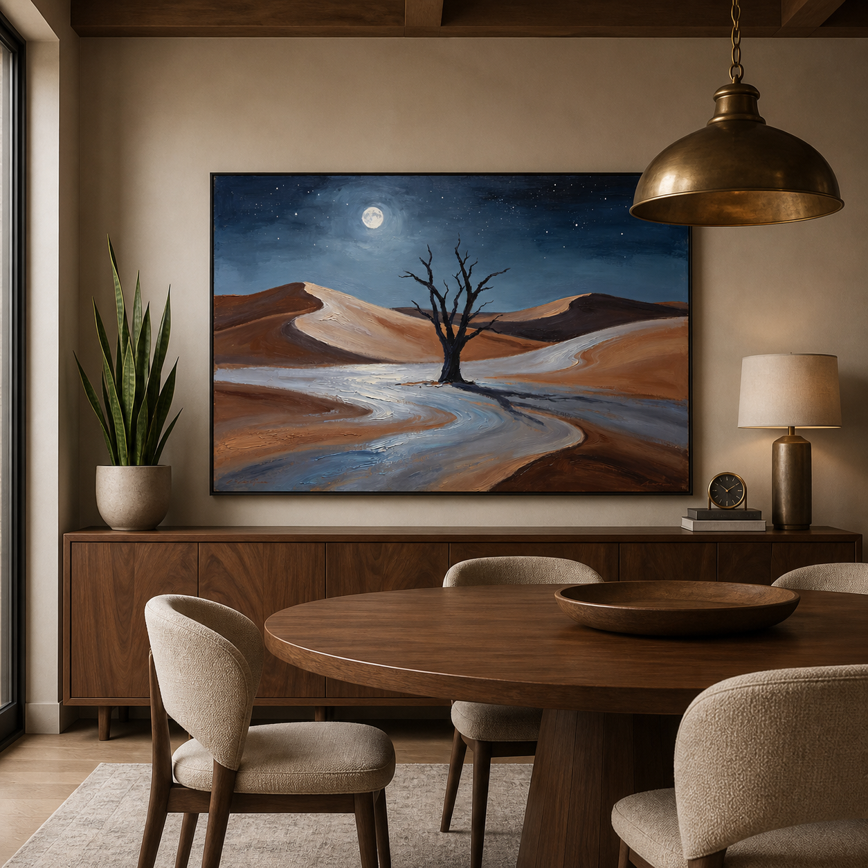 Bare tree among rust-colored desert dunes beneath a blue sky and bright moon, shown in a room setting