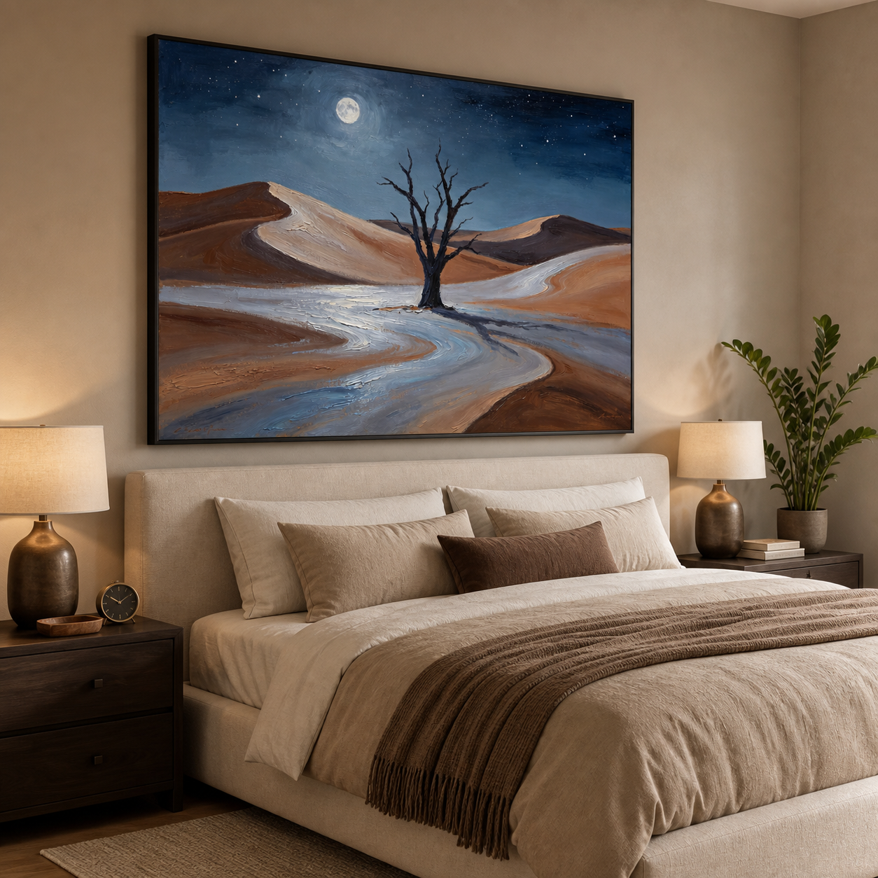 Bare tree among rust-colored desert dunes beneath a blue sky and bright moon, shown in a room setting