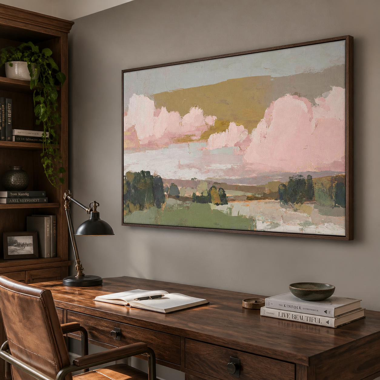 Large pink clouds above green fields and dark trees under a muted ochre sky, shown in a room setting