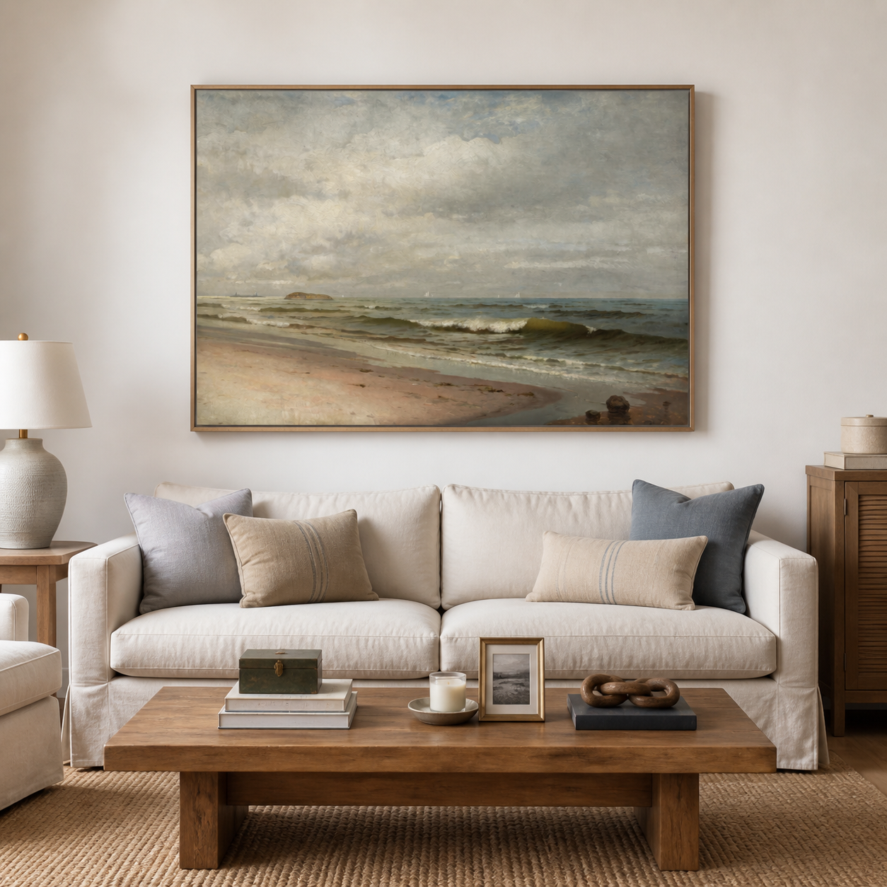 Olive-gray ocean waves rolling onto a sandy beach under a broad cloudy sky, shown in a room setting