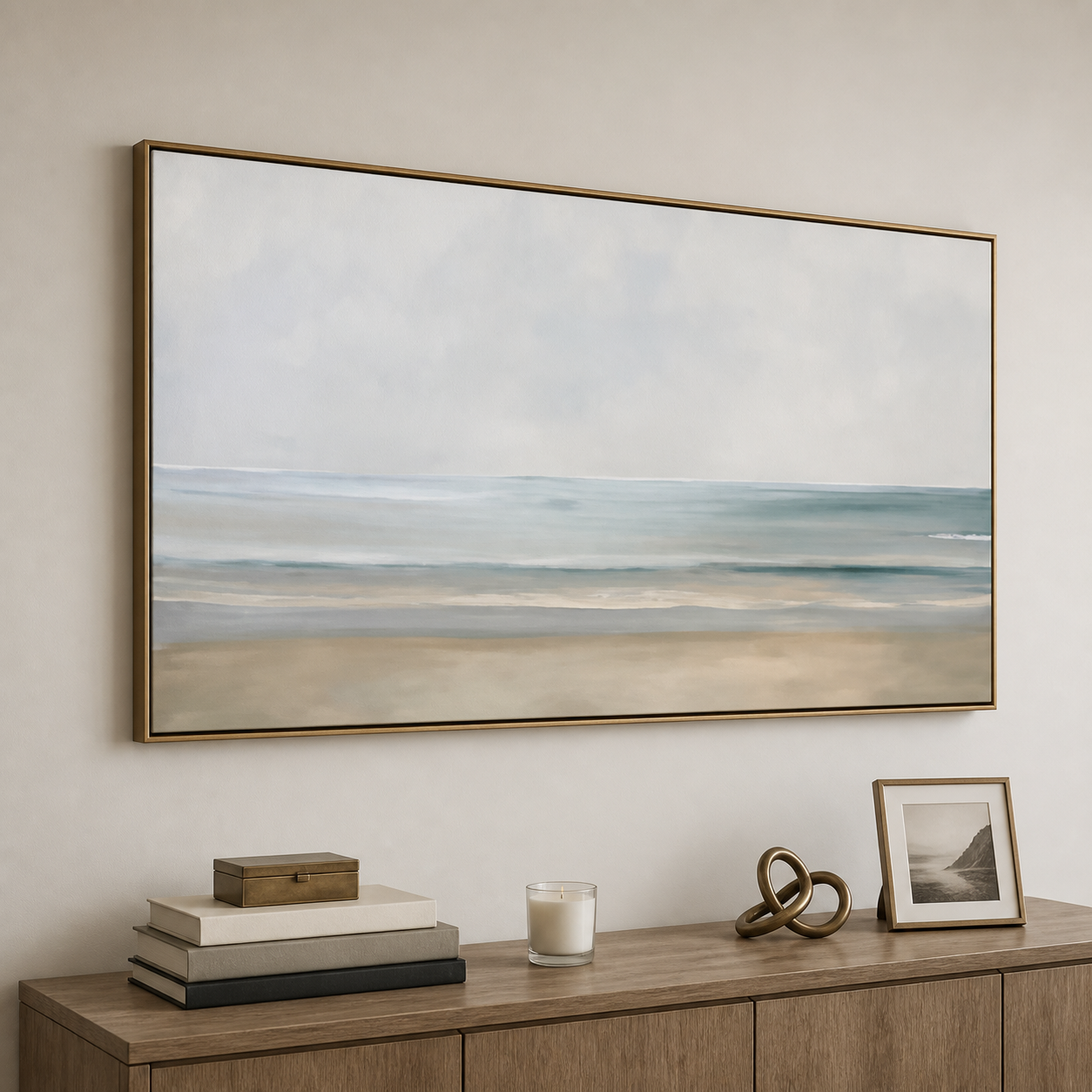 Minimalist ocean horizon with a pale sky, soft blue-green waves, and warm beige sand, shown in a room setting