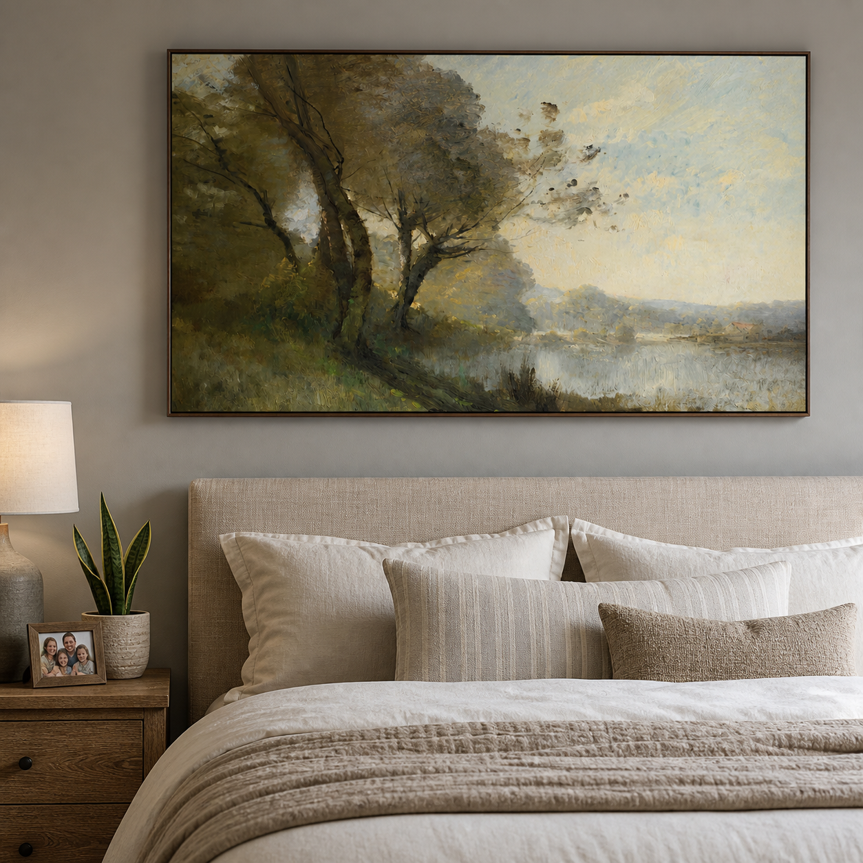 Olive green trees leaning over a quiet lake beneath a pale blue and cream sky, shown in a room setting