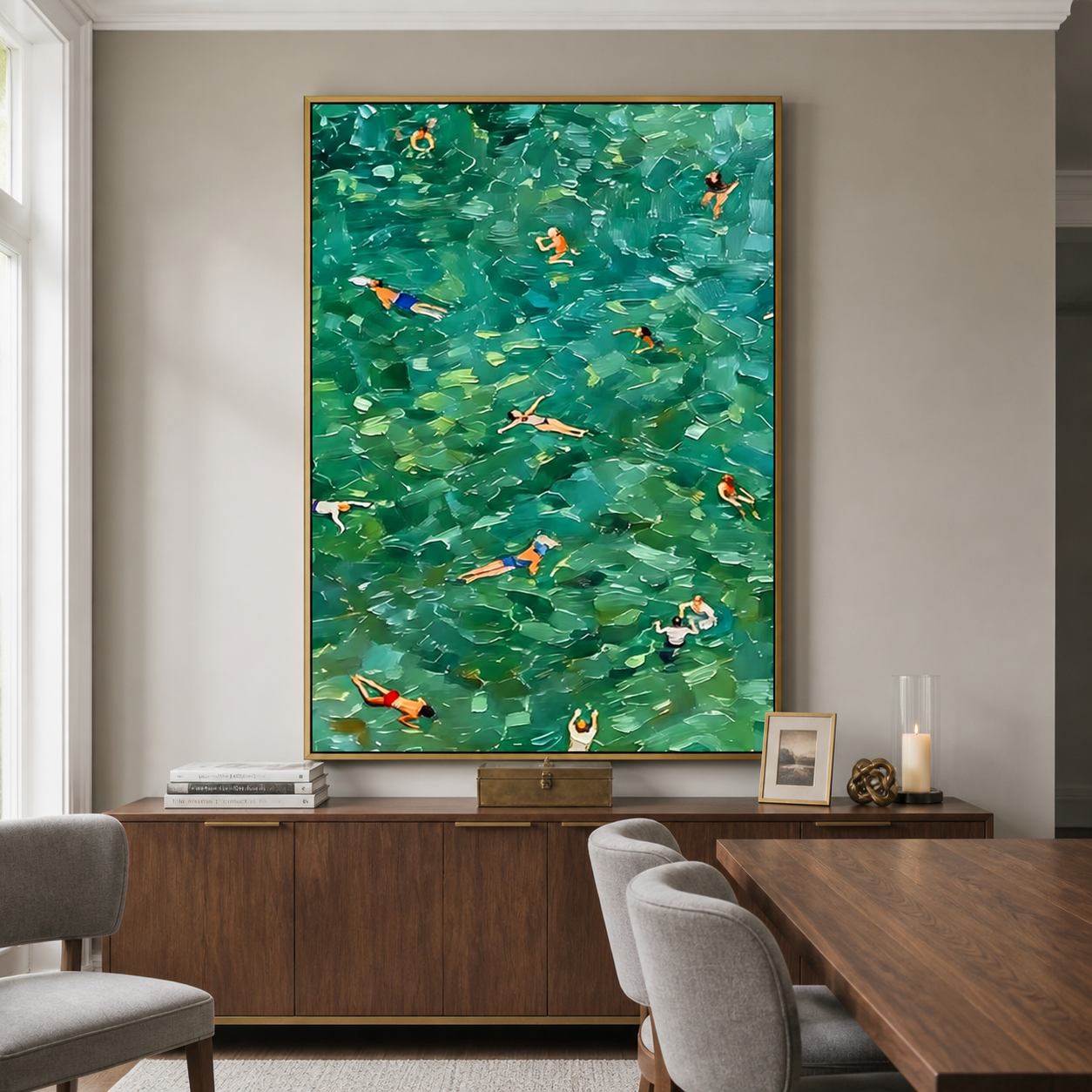 An overhead view of swimmers scattered across emerald green and turquoise water, shown in a room setting