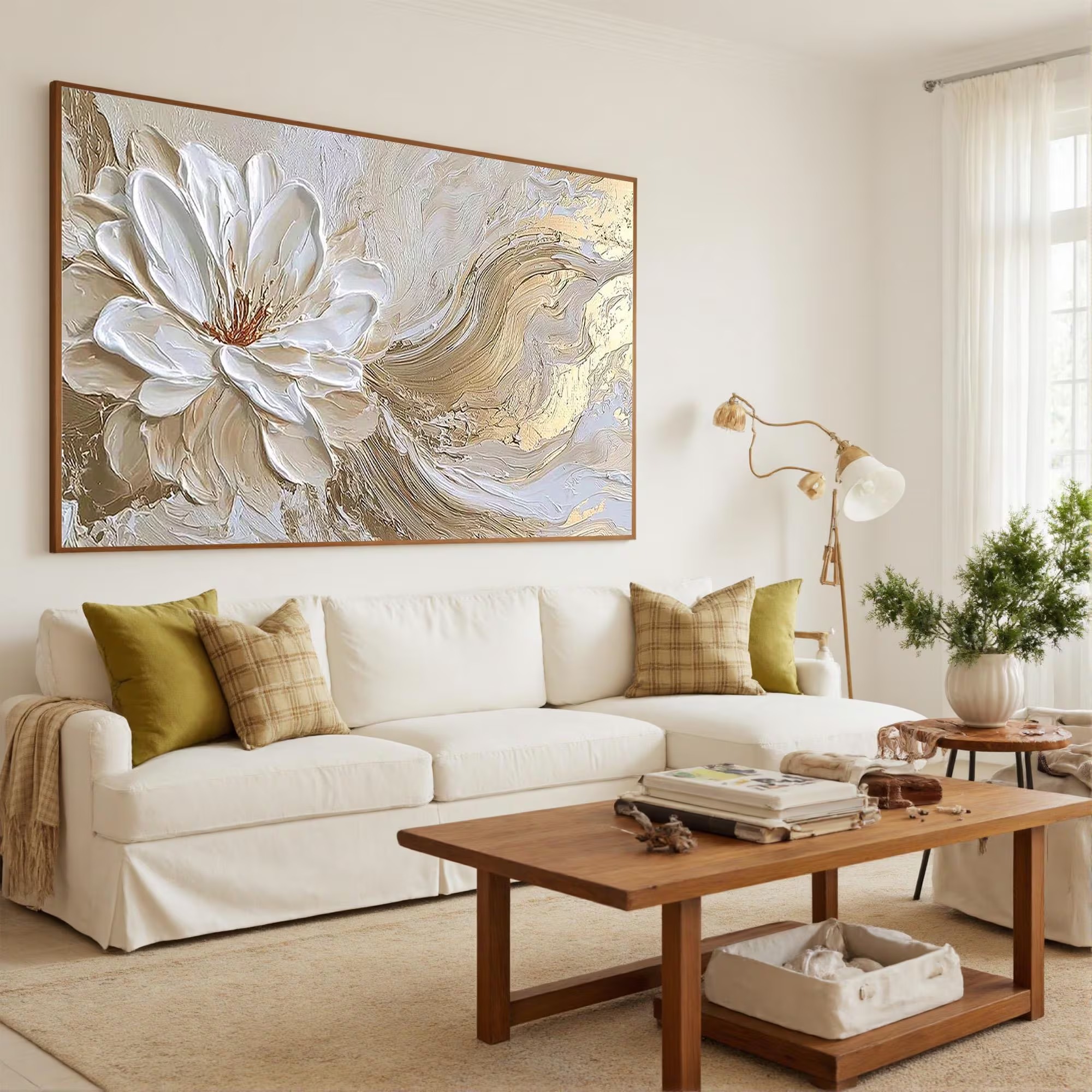 Large white flower beside flowing gold-toned and cream curves, shown in a room setting