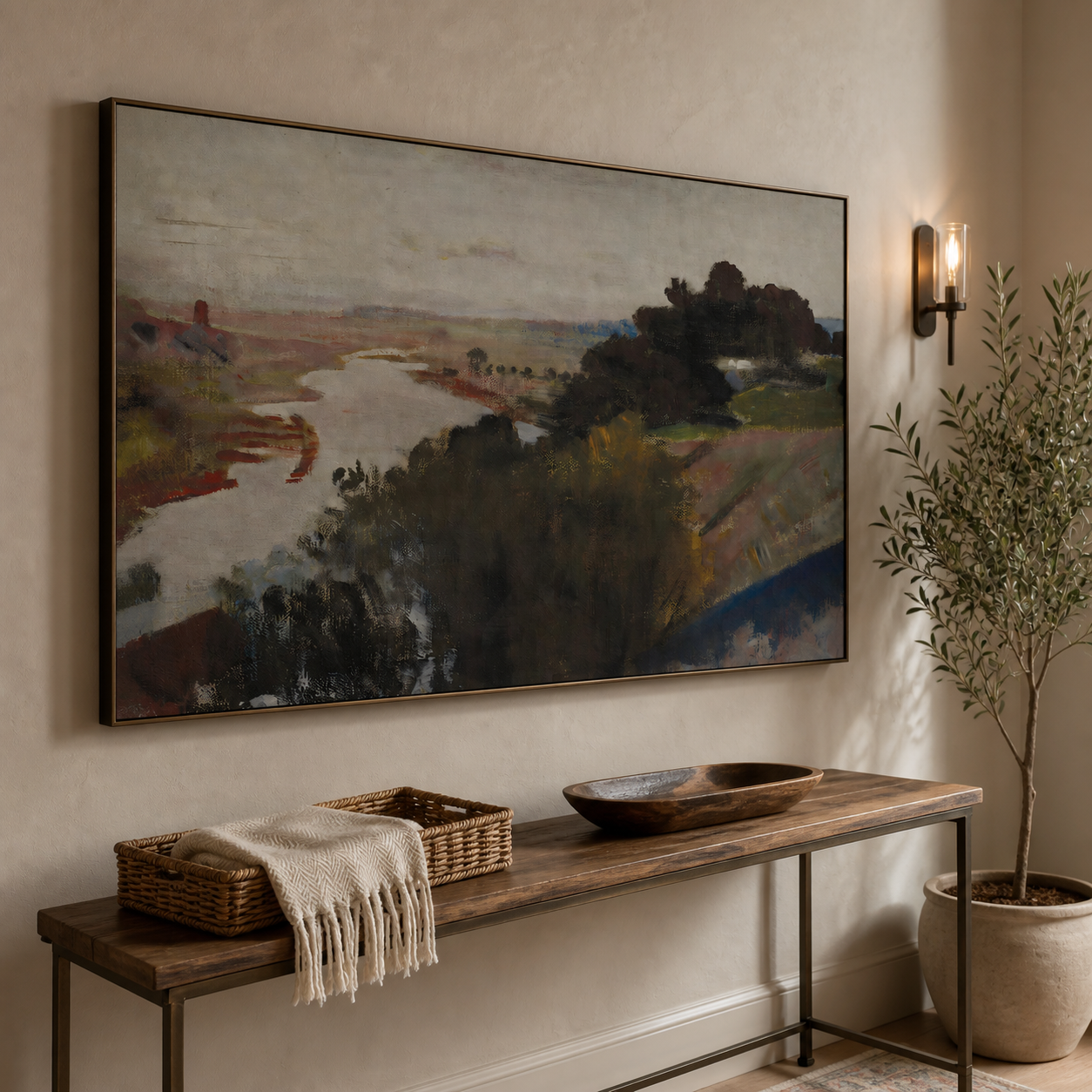 A winding pale river through muted rust and olive countryside with dark trees and a gray sky, shown in a room setting