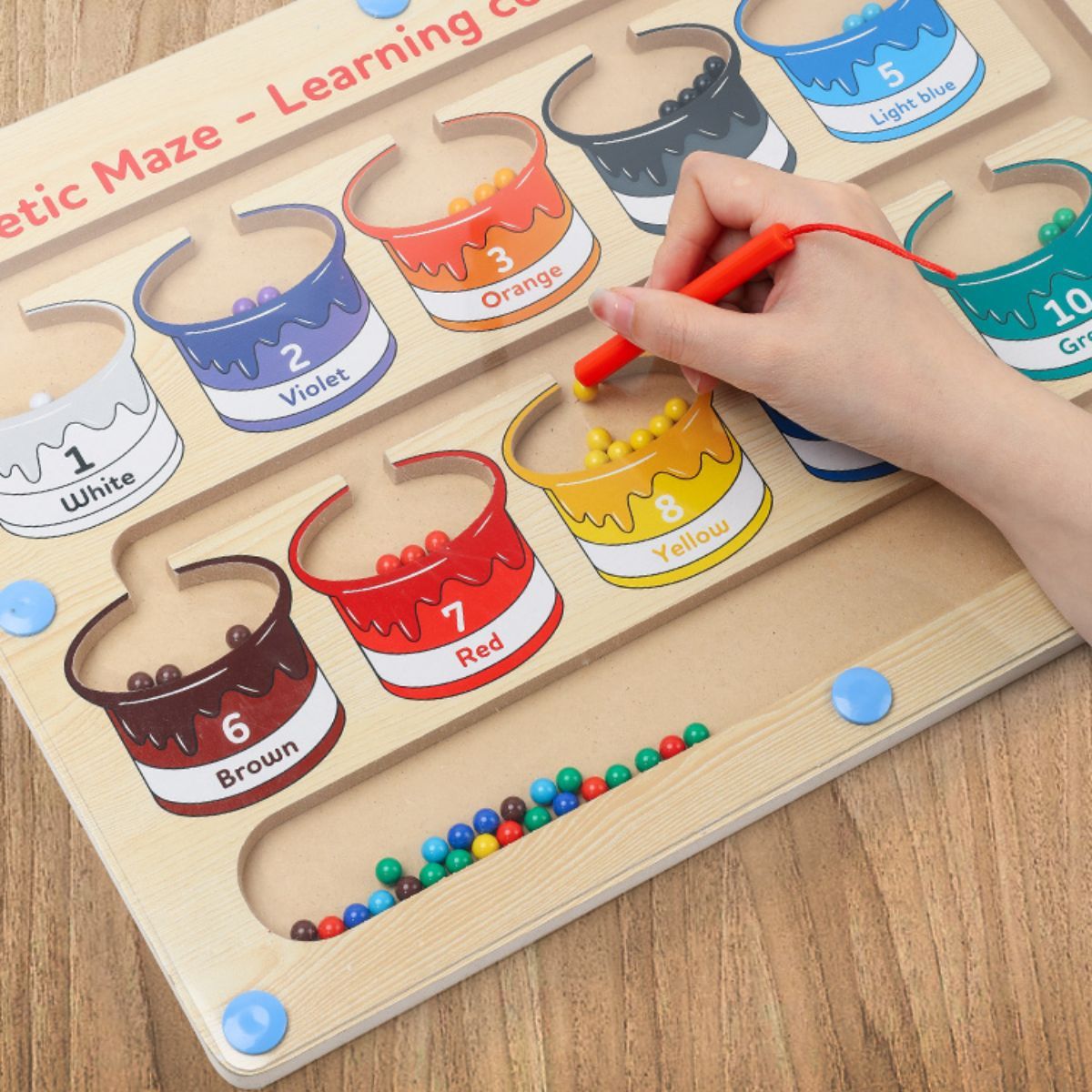 The wooden toy for learning fine motor skills is a magnetic maze designed for colors and numbers, suitable for young children and preschoolers.